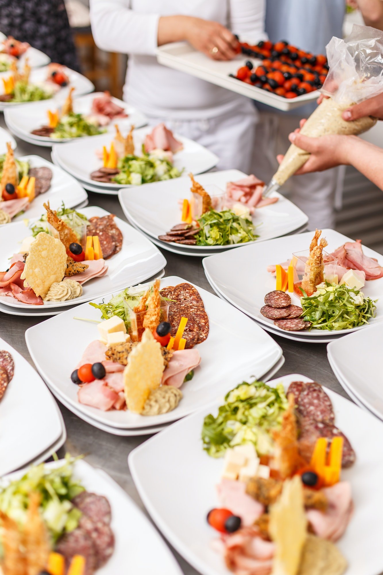 Plated appetizers with meat and cheese.