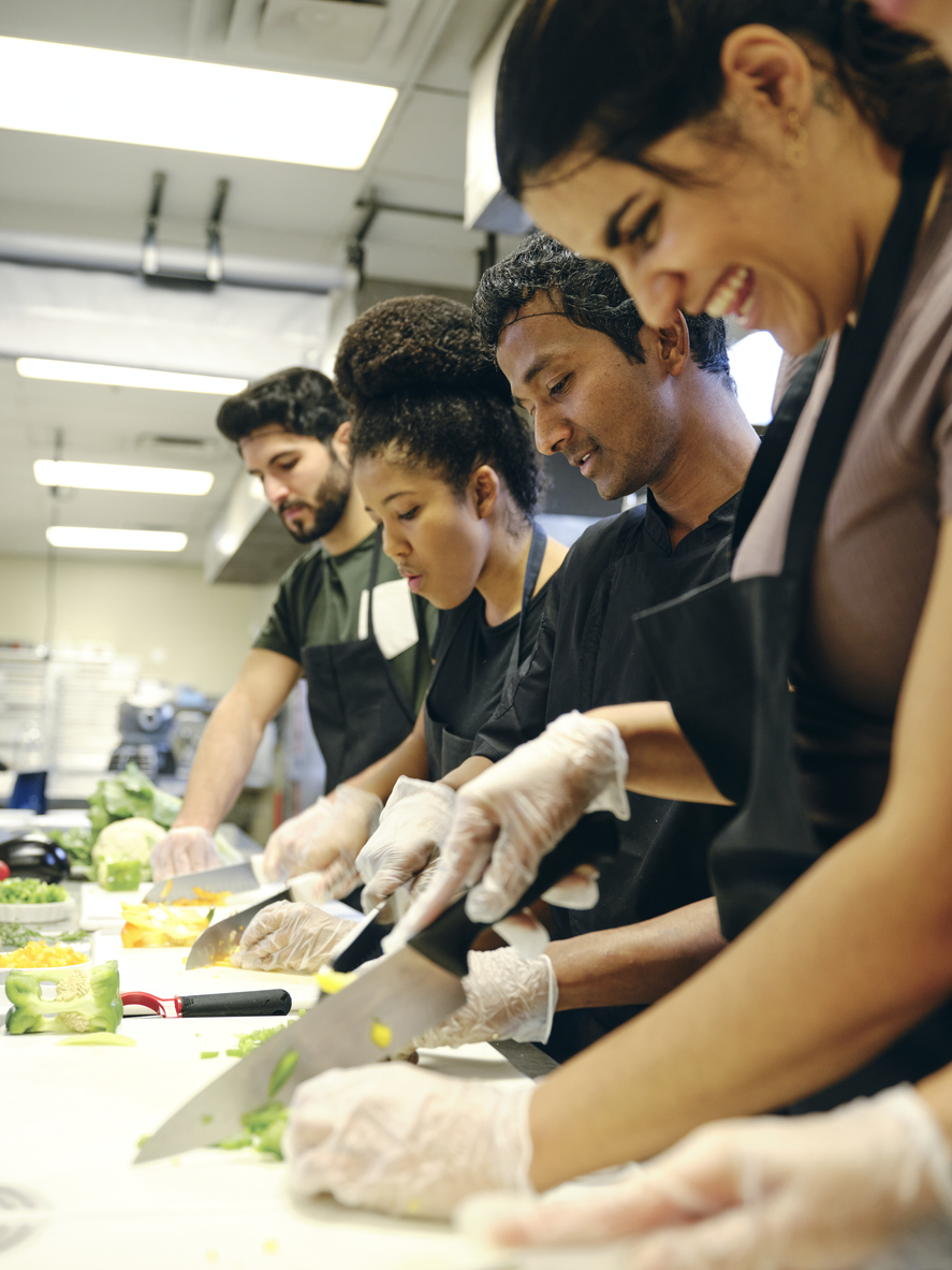 People preparing food in a kitchen.